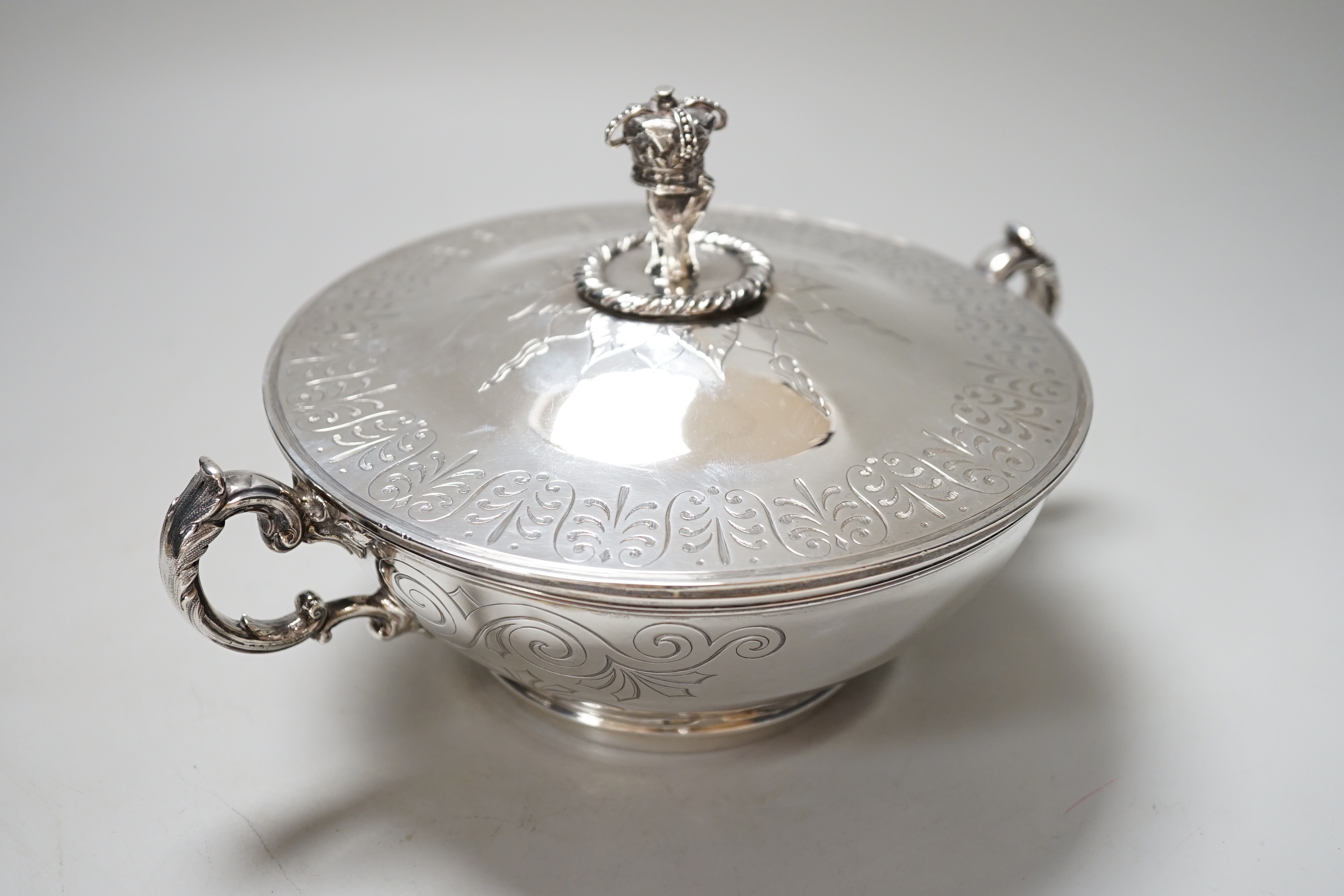 A Victorian silver tureen and cover, with hand holding crown finial and stylised anthemion engravings, makers initials W.T, London 1867, 23cm over handle, 673 grams
